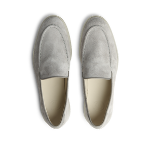 A pair of comfortable Cement Grey Suede Leather Debonair Loafers by CQP displayed against a black background.