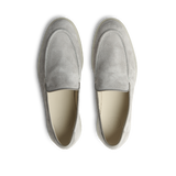 A pair of comfortable Cement Grey Suede Leather Debonair Loafers by CQP displayed against a black background.