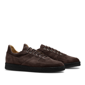 A pair of CQP Chocolate Brown Roamer Sneakers, featuring handcrafted suede leather with black rubber soles and white laces, shown from a side angle.