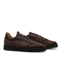 A pair of CQP Chocolate Brown Roamer Sneakers, featuring handcrafted suede leather with black rubber soles and white laces, shown from a side angle.