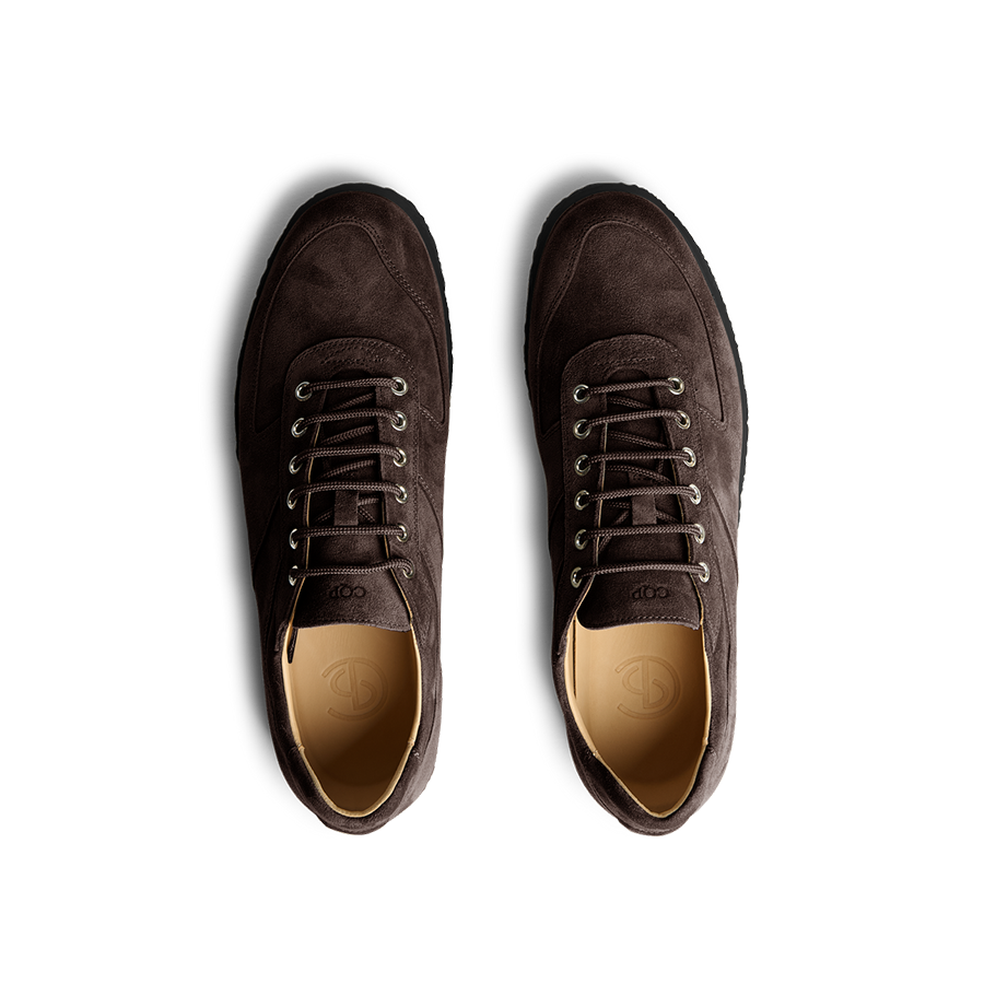 A pair of Chocolate Brown Suede Leather Roamer Sneakers by CQP with a simple lace-up design, viewed from above.