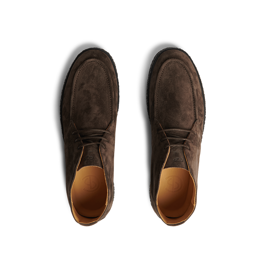 A pair of Chocolate Brown Suede Leather Plana Boots from CQP, featuring a tan interior lining and crepe sole, viewed from above.