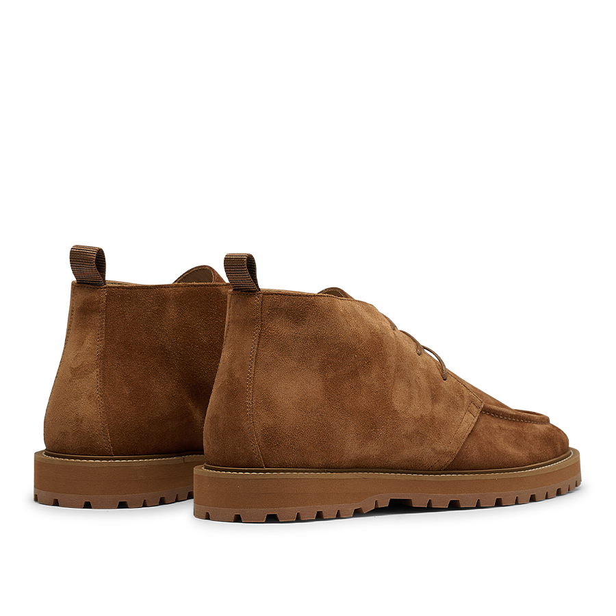 A pair of Cognac Suede Leather Astra Desert Boots by CQP, featuring rugged soles, pull tabs at the back, and a lace-up closure.