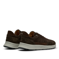 A pair of Dark Brown Suede Leather Renna Sneakers by CQP, featuring white rubber VIBRAM soles and crafted from premium materials, shown from a rear three-quarter angle.