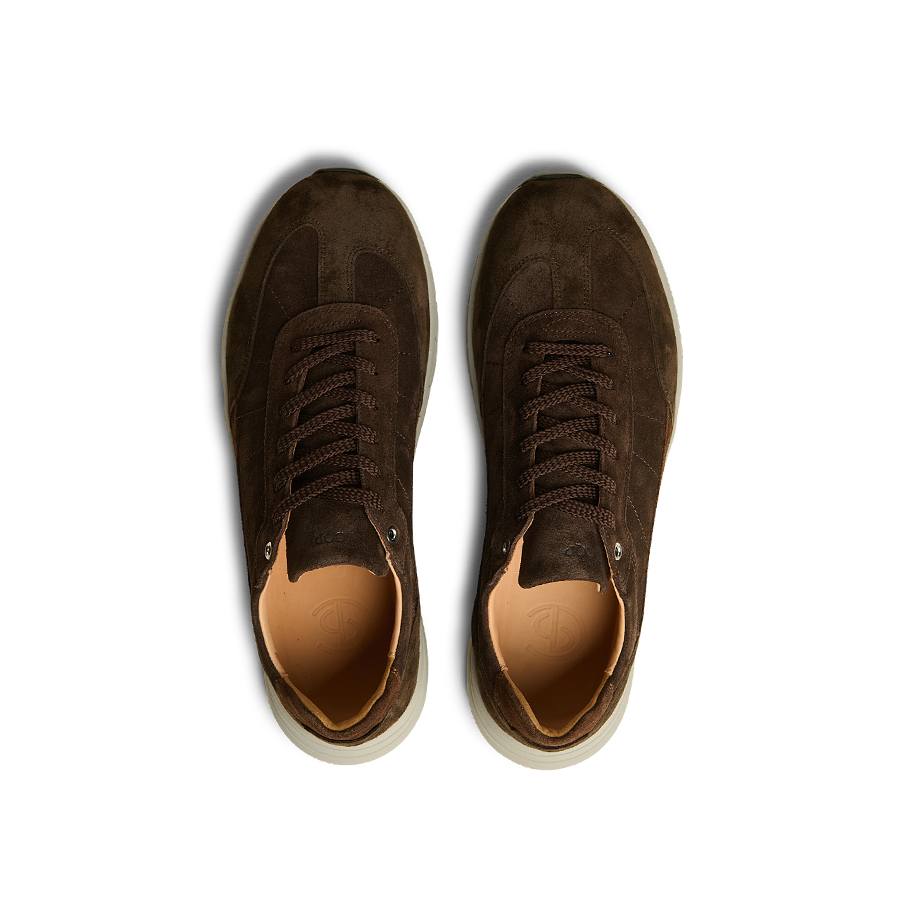 A pair of Dark Brown Suede Leather Renna Sneakers by CQP with beige interiors and VIBRAM white soles, viewed from above, showcasing premium materials.