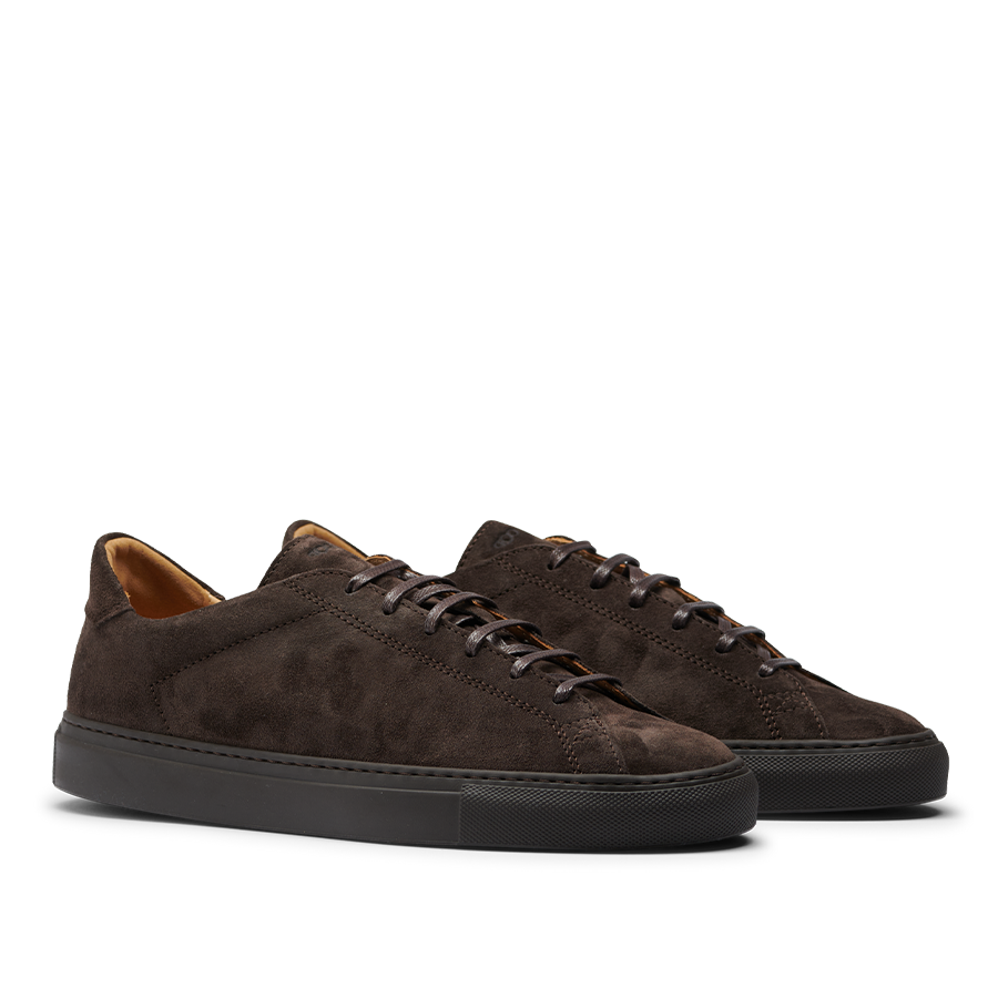 The CQP Ebony Brown Racquet Sr Sneakers feature dark brown suede calf leather with black rubber soles and matching dark brown laces, offering enhanced comfort and improved arch support.