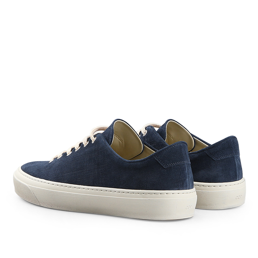 A pair of Indigo Blue Textured Suede Genoa Sneakers by CQP, featuring white rubber soles and light-colored laces, displayed from a rear angle.