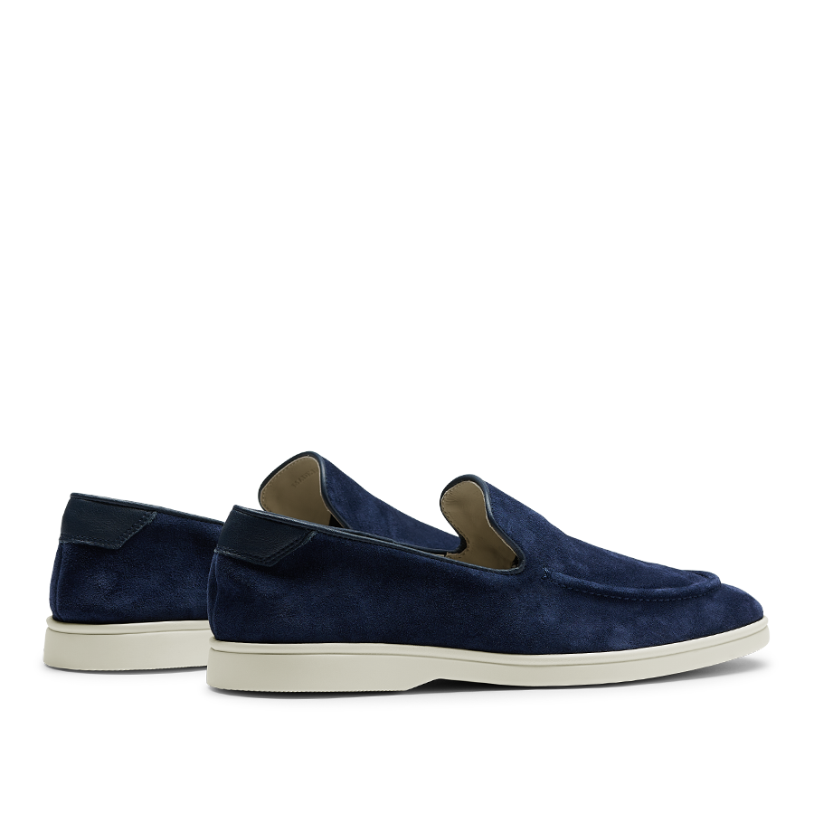 A pair of Navy Blue Suede Leather Debonair Slippers with white soles, designed by CQP, a Swedish designer.
