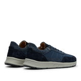 A side-angle view of a pair of Navy Suede Leather Renna Mesh Sneakers by CQP, featuring white VIBRAM soles and a combination of mesh and suede textures.