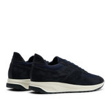 A pair of Obsidian Blue Suede Leather Stride Runners by CQP, with white Gommus soles, displayed side by side on a transparent background.