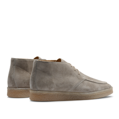 A pair of Taupe Beige suede leather Plana boots with crepe soles and laces, viewed from the side, against a transparent background.