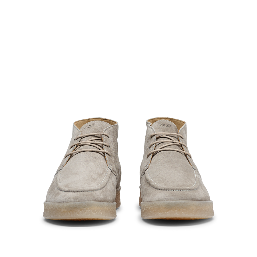 A pair of Taupe Beige Suede Leather Plana Boots with crepe soles and laces, viewed from the front, isolated on a white background.