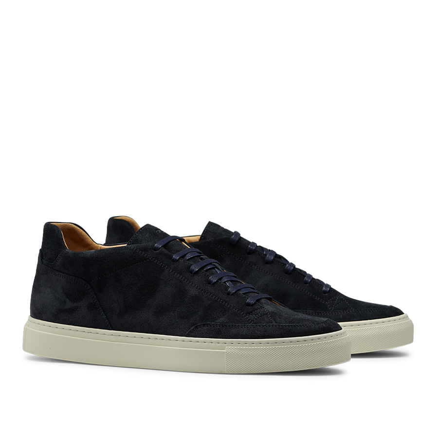 A pair of Prussian Blue Suede Leather Scion Sneakers by CQP, with a thick, cream-colored rubber sole, displayed side by side on a transparent background.