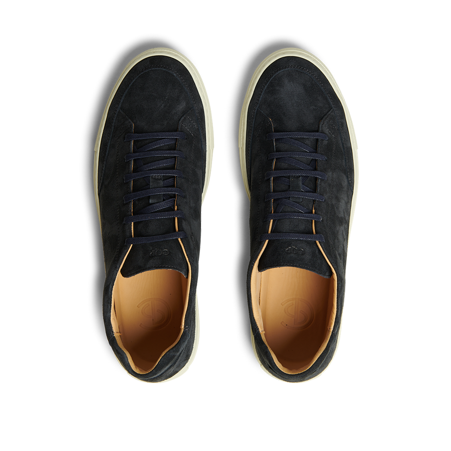 A pair of Prussian Blue Suede Leather Scion sneakers by CQP with matching laces and light brown inner soles, featuring a rubber sole, viewed from above on a transparent background.