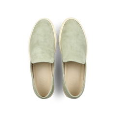 The Sage Green Textured Suede Jetty Wholecut Slip-On by CQP is a stylish, slipper-like shoe featuring light tan supportive rubber soles, viewed from above.