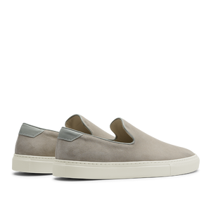 A pair of Sand Suede Leather Jetty Wholecut Slip-on sneakers with white soles and light grey accents on the heel, handmade in Portugal by CQP.