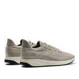 A pair of CQP Tahini Beige Suede Leather Stride Sneakers with white soles on a transparent background.