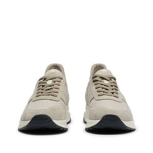 A pair of Tahini Beige Suede Leather Stride CQP sneakers with white laces and black soles, viewed from the front.