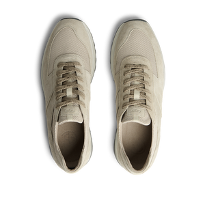 A pair of Tahini Beige Suede Leather Stride Sneakers by CQP, with laces, viewed from above on a transparent background.