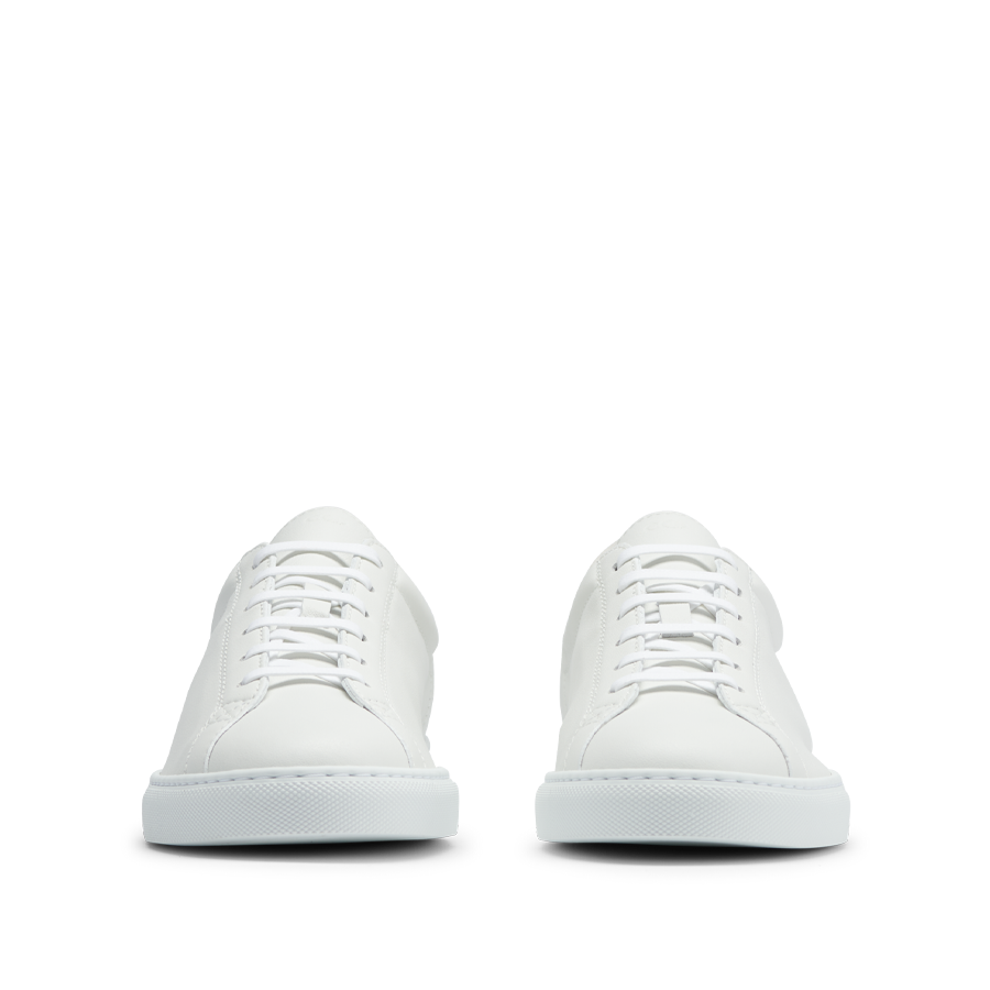 A pair of CQP White Leather Racquet Sneakers on a background.