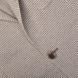 Close-up of a button on a Canali Beige Houndstooth Cotton Jersey Blazer.
