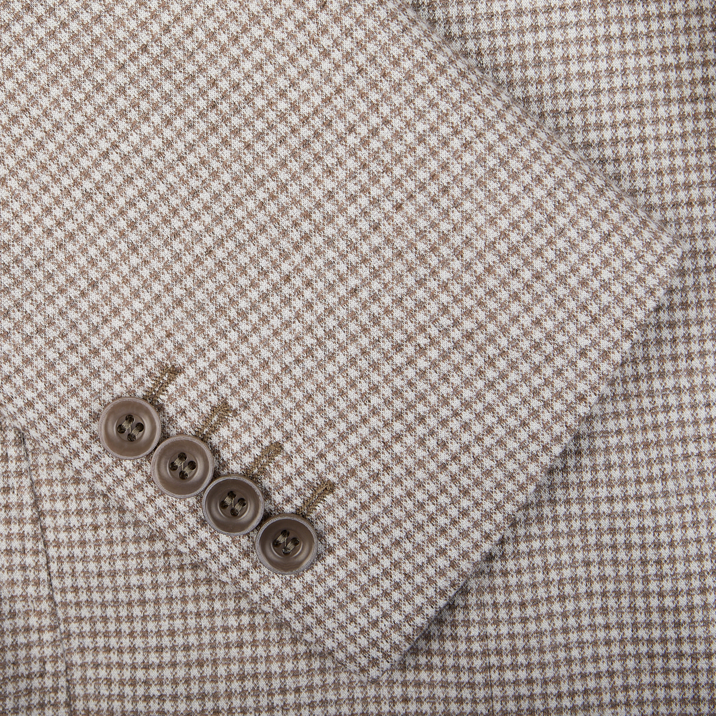 Close-up of a Canali Beige Houndstooth Cotton Jersey Blazer sleeve with four buttons.
