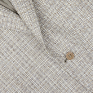 Close-up of a Canali Beige Melange Silk Wool Basketweave Blazer fabric with a visible button on the garment, highlighting the texture and pattern of the material.