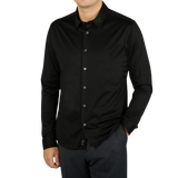 A contemporary man wearing a Canali Black Cotton Jersey Casual Shirt.