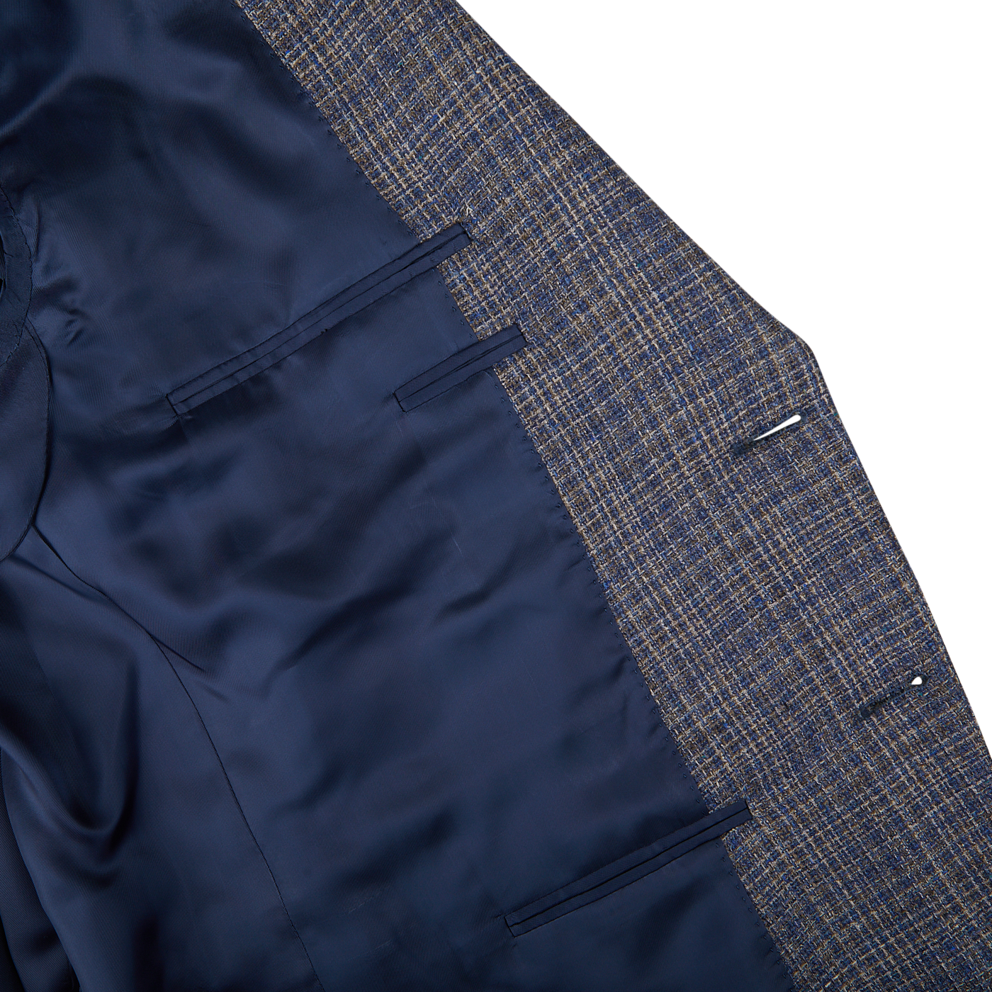 Close-up of a Canali Blue Melange Silk Wool Basketweave Blazer with one half in solid navy and the other in blue and yellow plaid, displayed on a flat surface.