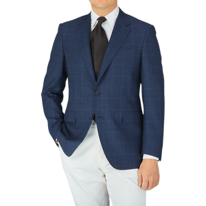 A man in a Canali Dark Blue Mini Gingham Wool Drop 6 Blazer, made with pure wool, posing for a photo.