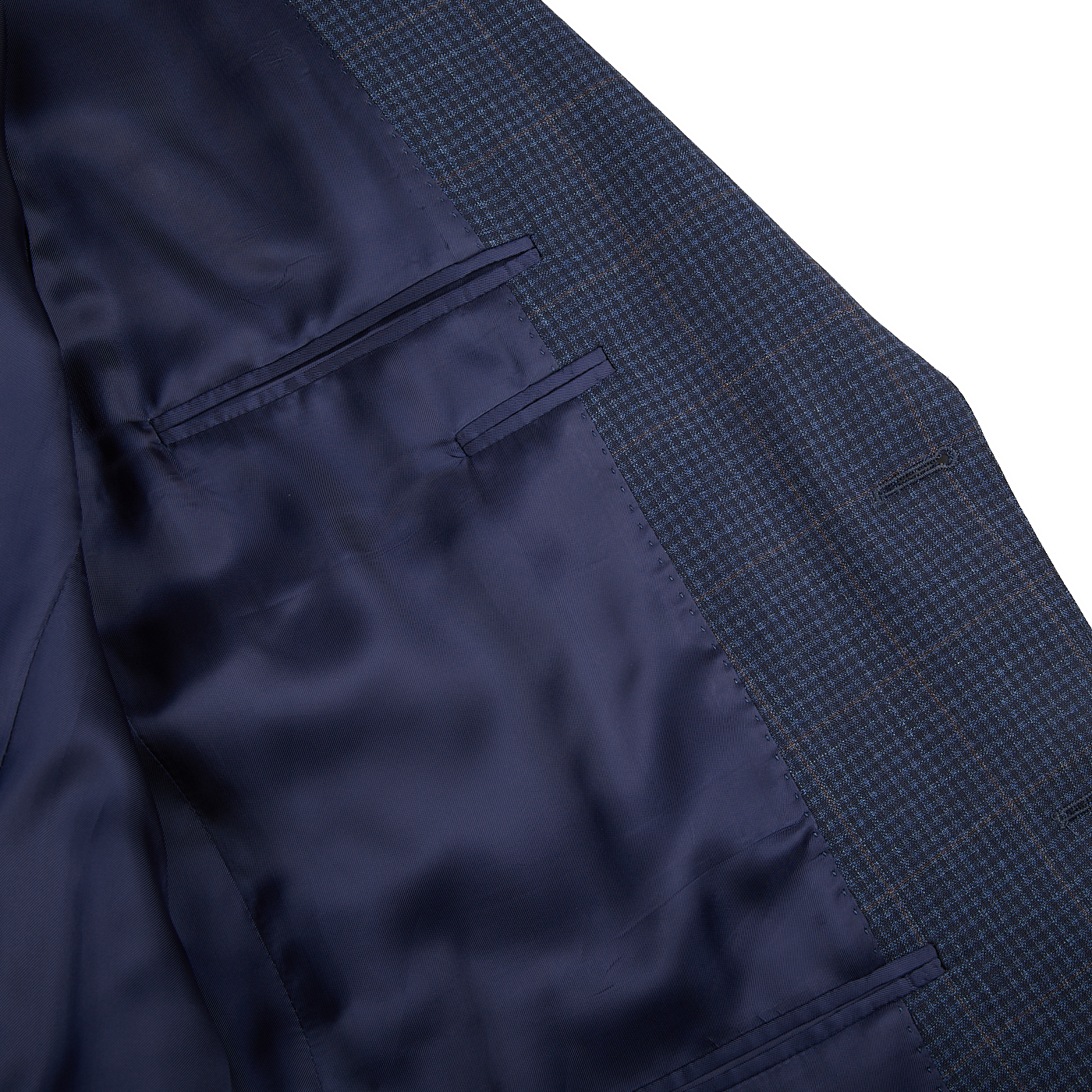 A close up of a dark blue mini gingham wool drop 6 blazer by Canali.