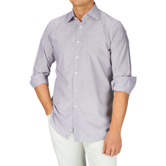 A man wearing a purple Canali shirt and white pants.