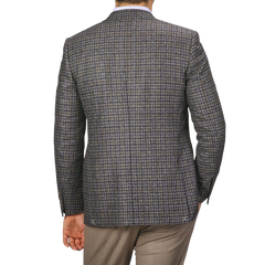 A person wearing a Canali Brown Gunclub Check Wool Drop 6 Blazer and brown trousers, photographed from behind.