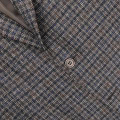 Close-up of the Canali Brown Gunclub Check Wool Drop 6 Blazer, showcasing its pure wool construction in a brown-blue houndstooth pattern, with a visible button and pocket.