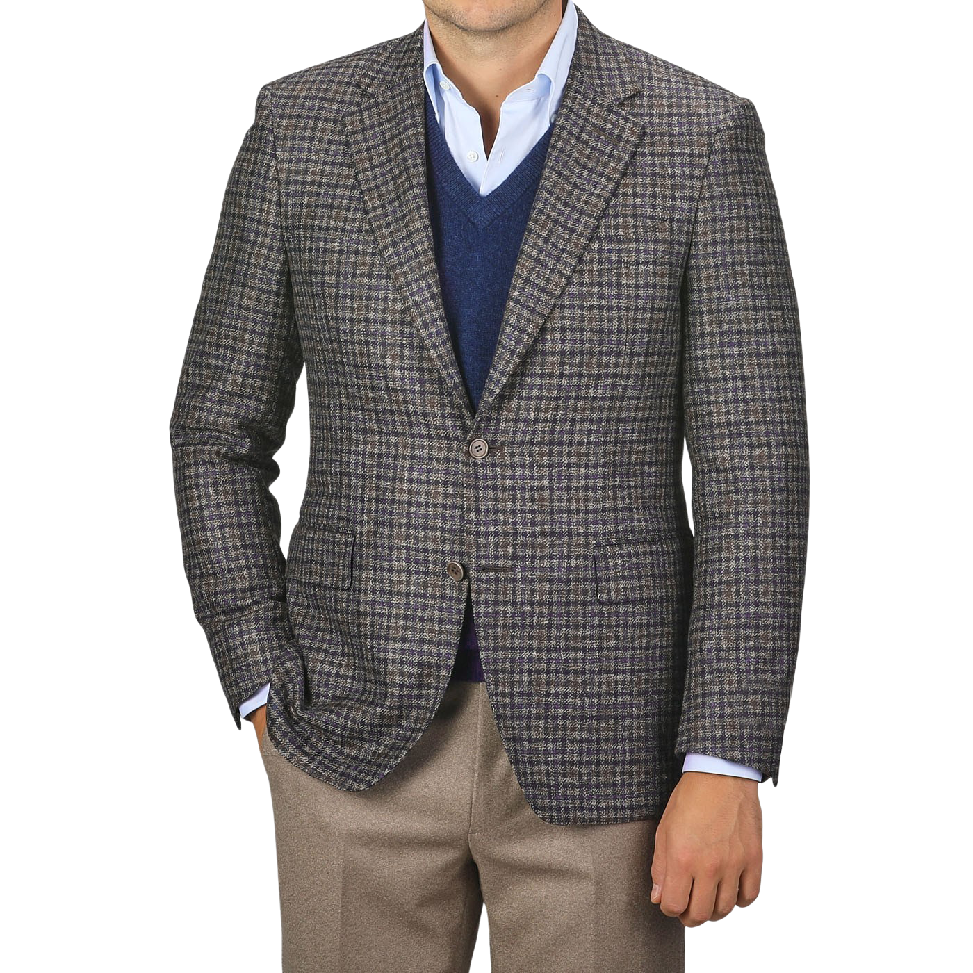 A man wearing a Canali Brown Gunclub Check Wool Drop 6 Blazer over a blue sweater and light blue shirt, paired with khaki pants, stands with one hand in his pocket.