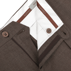 Close-up of tailored Canali Brown Matte Wool Flat Front Trousers, featuring zipper and black button detail, highlighting the interior label and meticulous stitching.