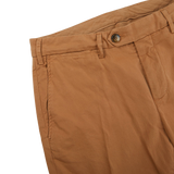 A close up of a pair of Canali Terracotta Cotton Stretch Flat Front Chinos with a distressed appearance.