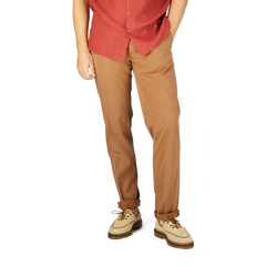 A man in a red shirt and Canali terracotta cotton stretch flat front chinos.