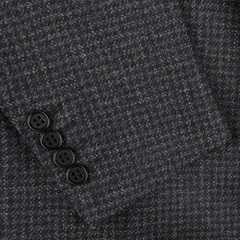 Close-up of a sleeve from the Canali Dark Blue Checked Wool Drop 6 Blazer, showcasing four sleek black buttons.