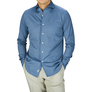 A man wearing a dark blue Canali cotton jersey casual shirt and khaki pants embodies modern-day working life.