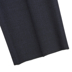 Close-up of Canali's Dark Blue Melange Wool Flat Front Trousers, showcasing the cleanly cut, unhemmed edges against a light gray background.