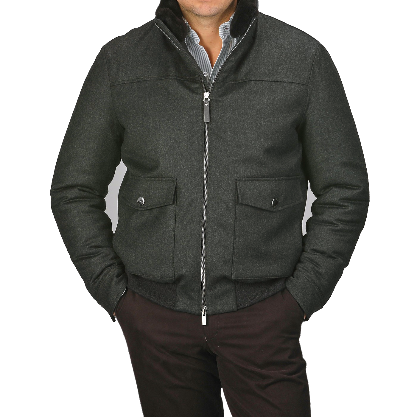 A person wearing a Canali dark green bomber jacket with a wool fur collar and two front pockets stands against a plain gray background.