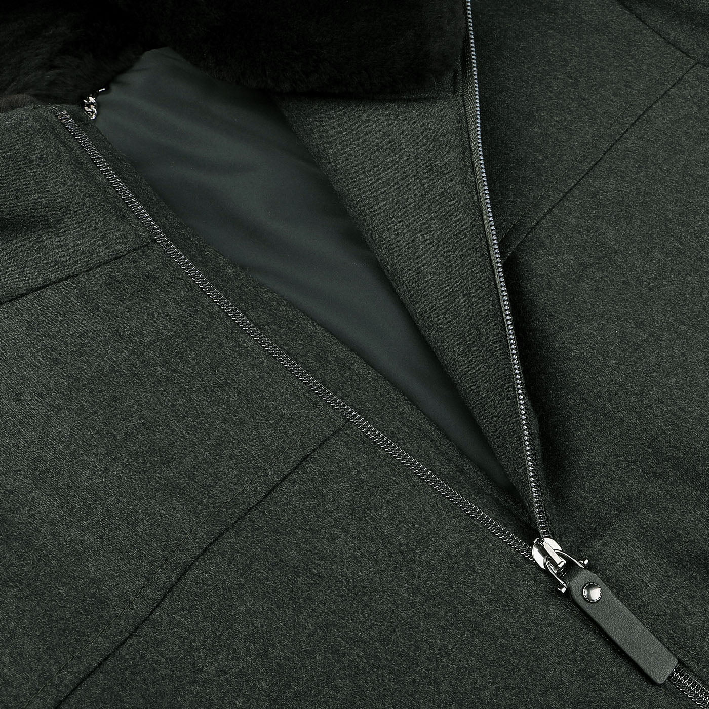 Close-up of a partially unzipped Dark Green Wool Fur Collar Bomber Jacket by Canali, featuring a visible silver zipper, a wool exterior, and a black interior lining.