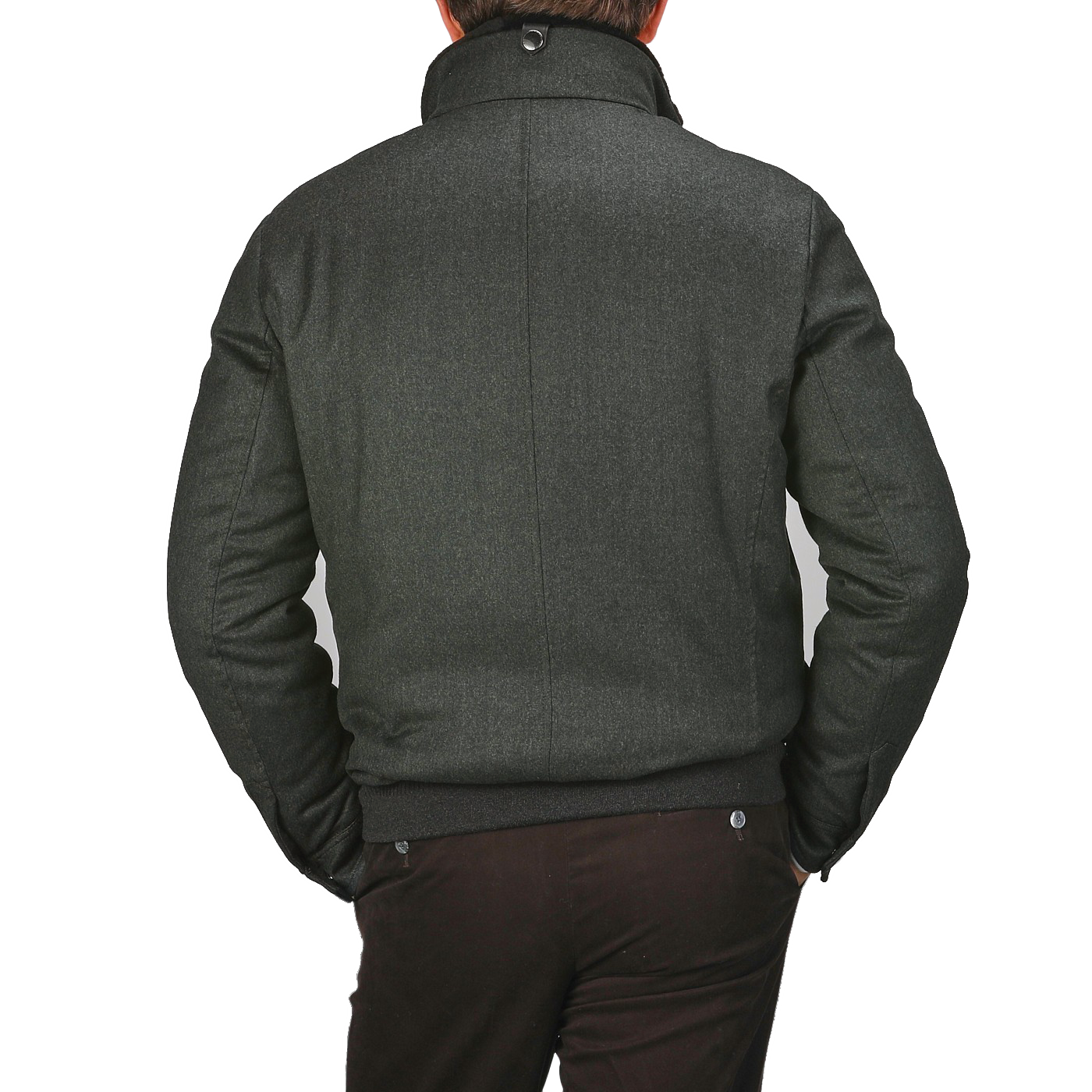 A person wearing a Canali dark green wool fur collar bomber jacket with hands in pockets, viewed from behind, highlights its elegant exterior.