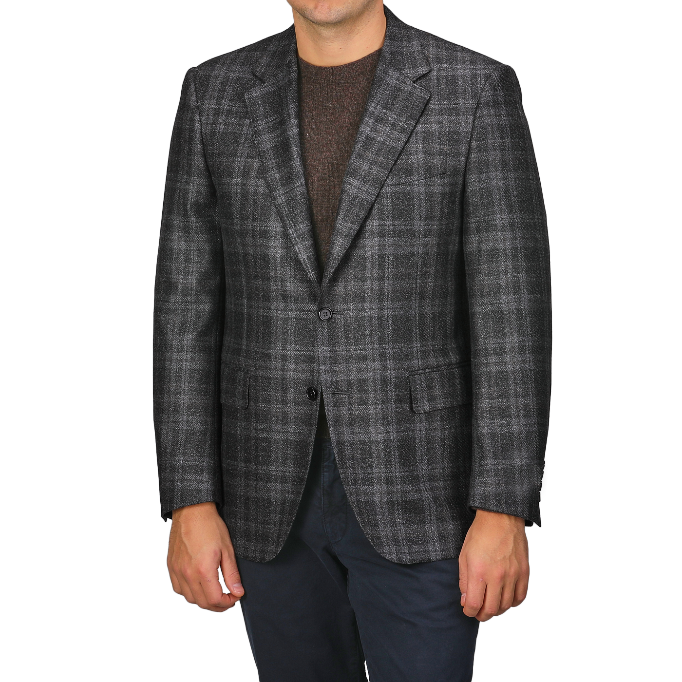 A person wearing a Canali Dark Grey Checked Wool Silk Drop 6 Blazer, a brown sweater, and navy pants stands against a plain background.