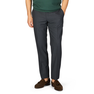 Man wearing Canali dark grey tropical wool flat front trousers and brown loafers without showing the upper body.