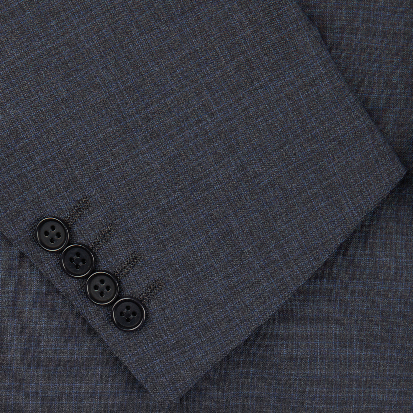 Close-up photo of a dark gray Canali Grey-Blue Melange Wool Suit fabric with a set of black buttons arranged in a line on it.
