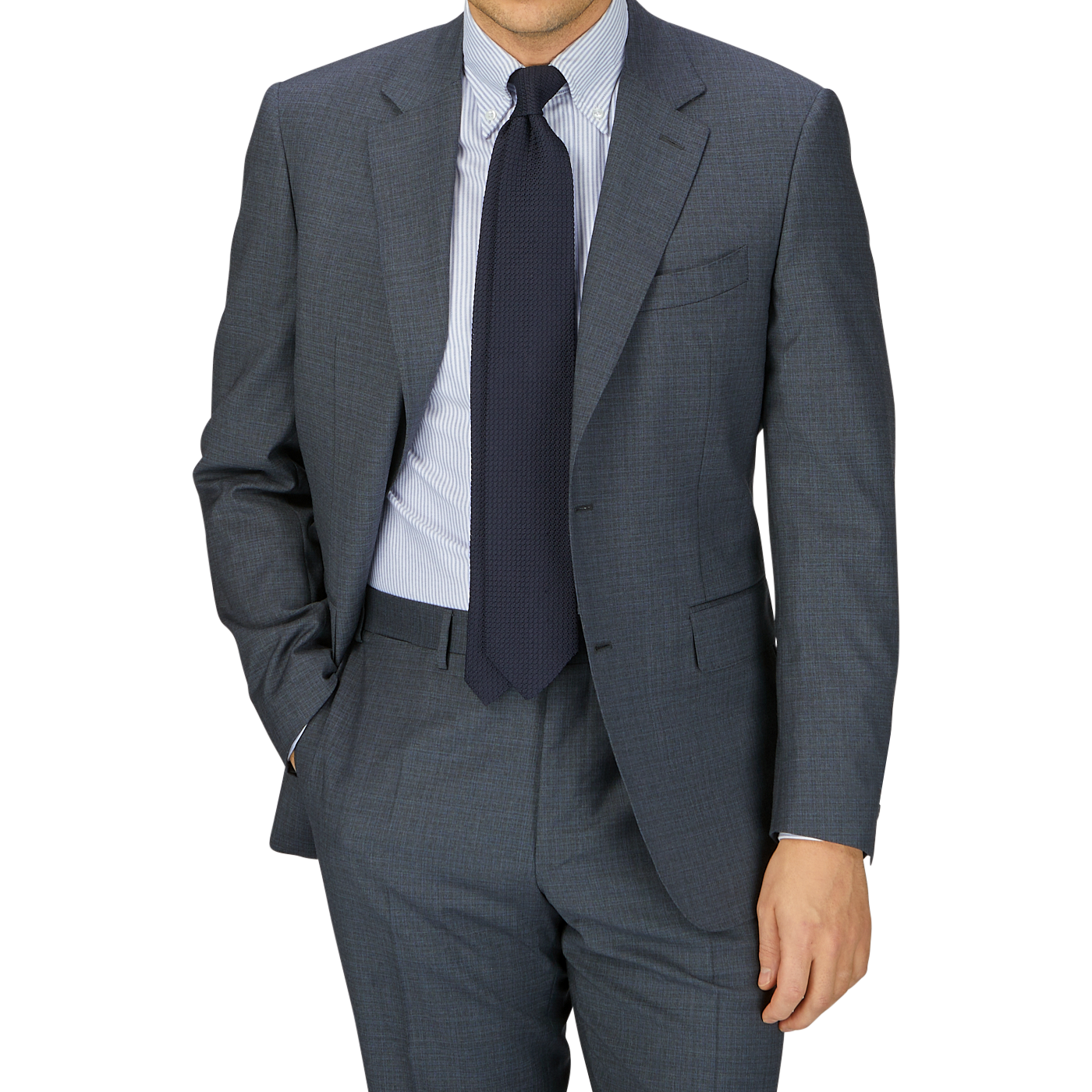 A man in a tailored Canali Grey-Blue Melange Wool Suit with a blue tie and striped shirt, posing with one hand in his pocket against a gray background.