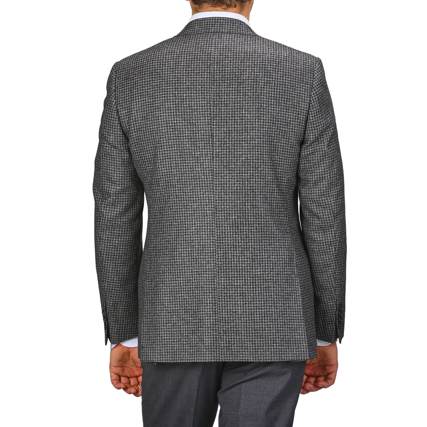 A person clad in the Grey Dogtooth Wool Drop 6 Blazer from Canali and matching gray pants, tailored from pure wool, is captured from the back with their arms hanging by their sides.