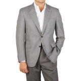 A man is posing for a photo in a Grey Houndstooth Wool Drop 6 Blazer from Canali.